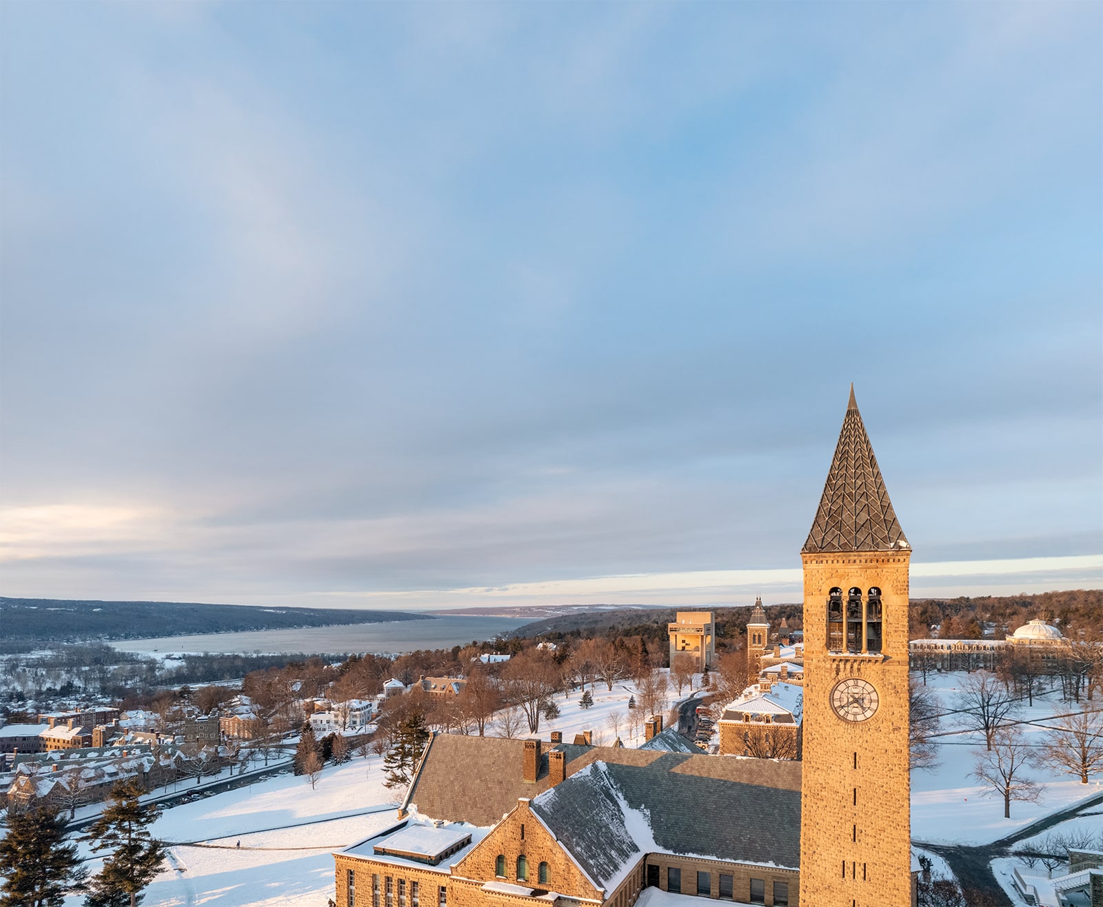 aerial view of cornell university and clocktower in the winter